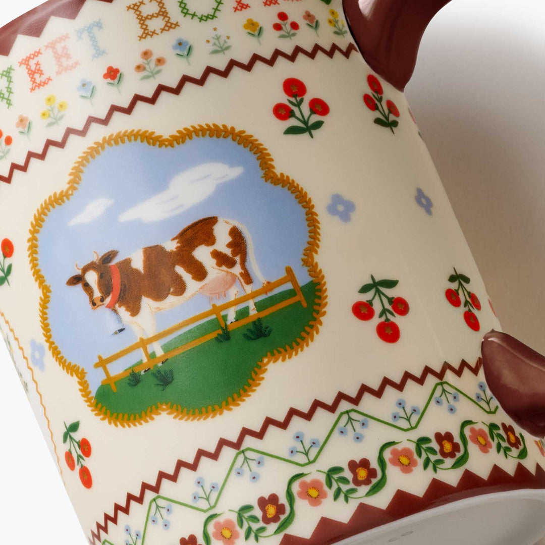 Decorative plate with a cow illustration and colorful border