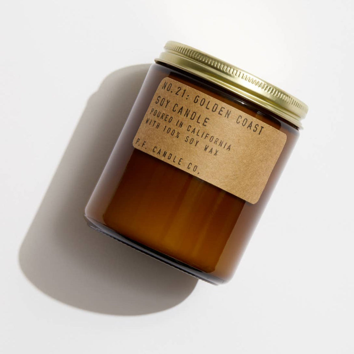 Soy candle in a jar with a label on a white background
